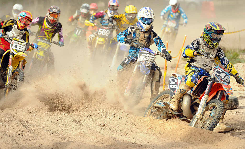 Riders scramble for positions on the first corner of the Clubman Lites race at the Hervey Bay Motocross. Riders scramble for positions on the first corner of the Clubman Lites race at the Hervey Bay Motocross.